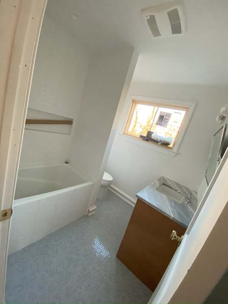 A spotless image of a bathroom with a bathtub