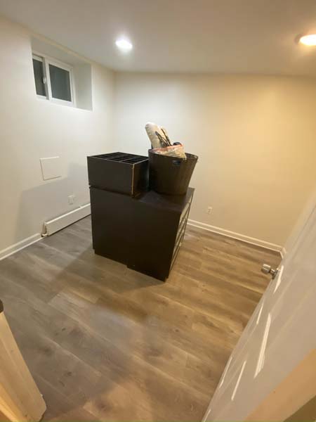 An image of a clean empty room few stacked boxes